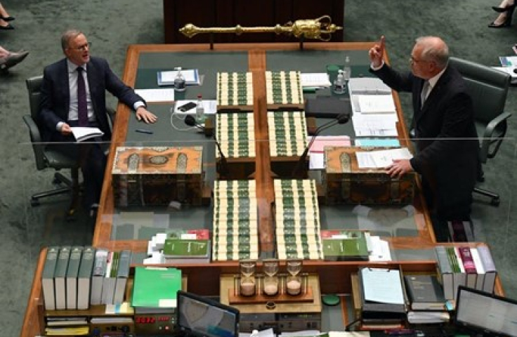 picture of two men at a desk in parliament house 